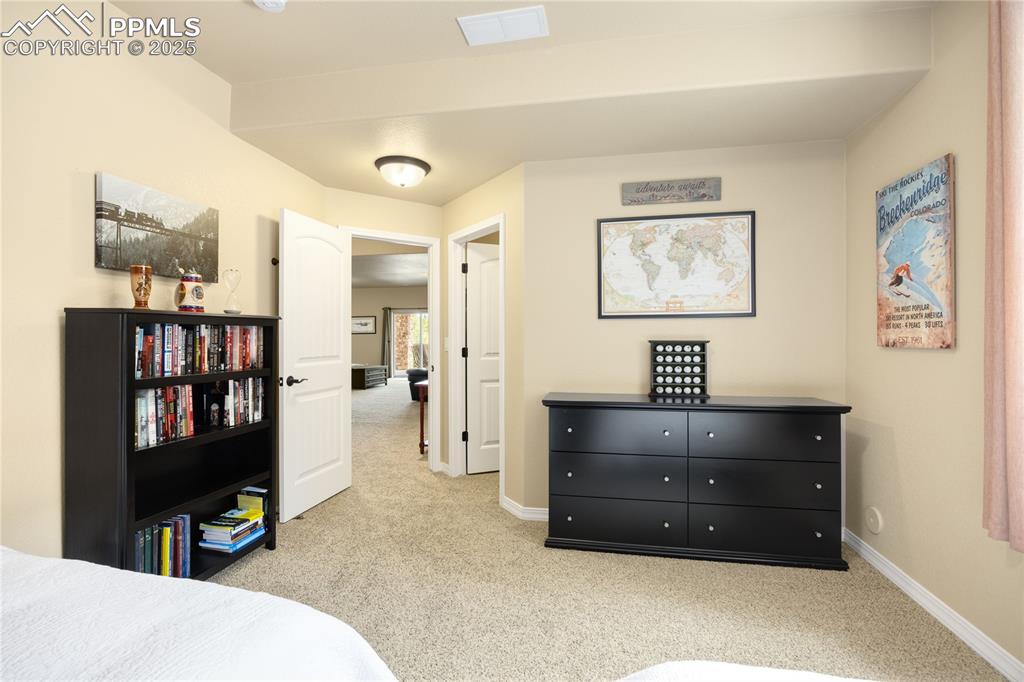 Carpeted bedroom with baseboards