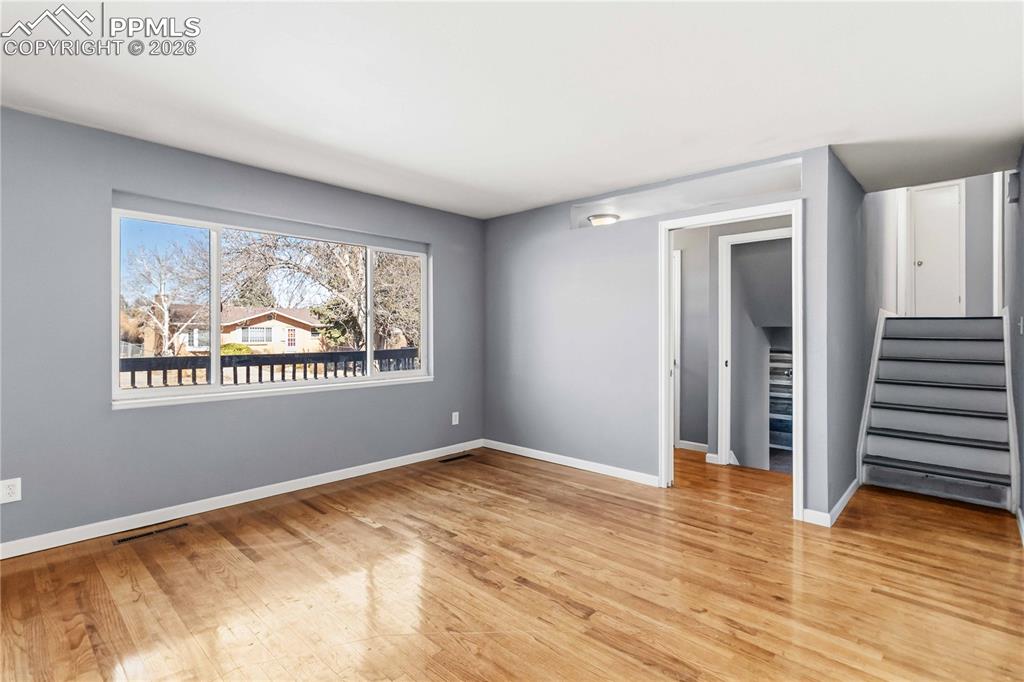 Stairs lead to the primary bedroom and two additional bedrooms. 