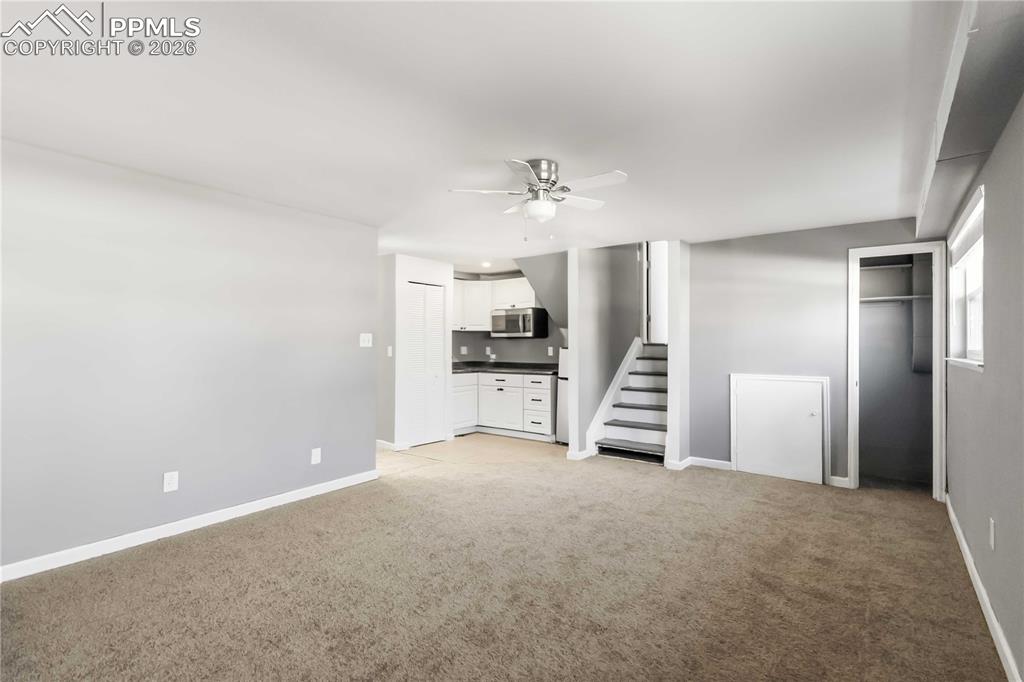 Garden level living room with kitchenette and a bedroom.
