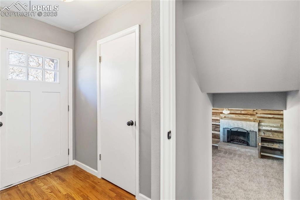 Basement off entryway has a living room, bedroom, kitchenette, and bathroom.