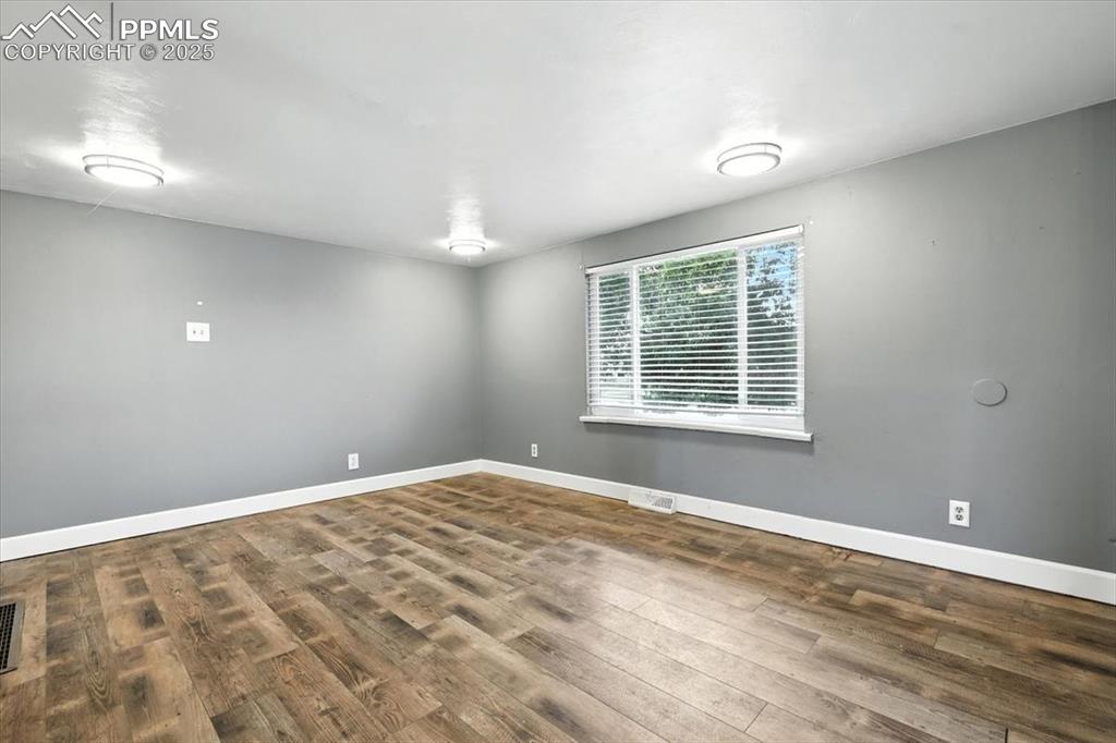Empty room featuring wood finished floors and baseboards
