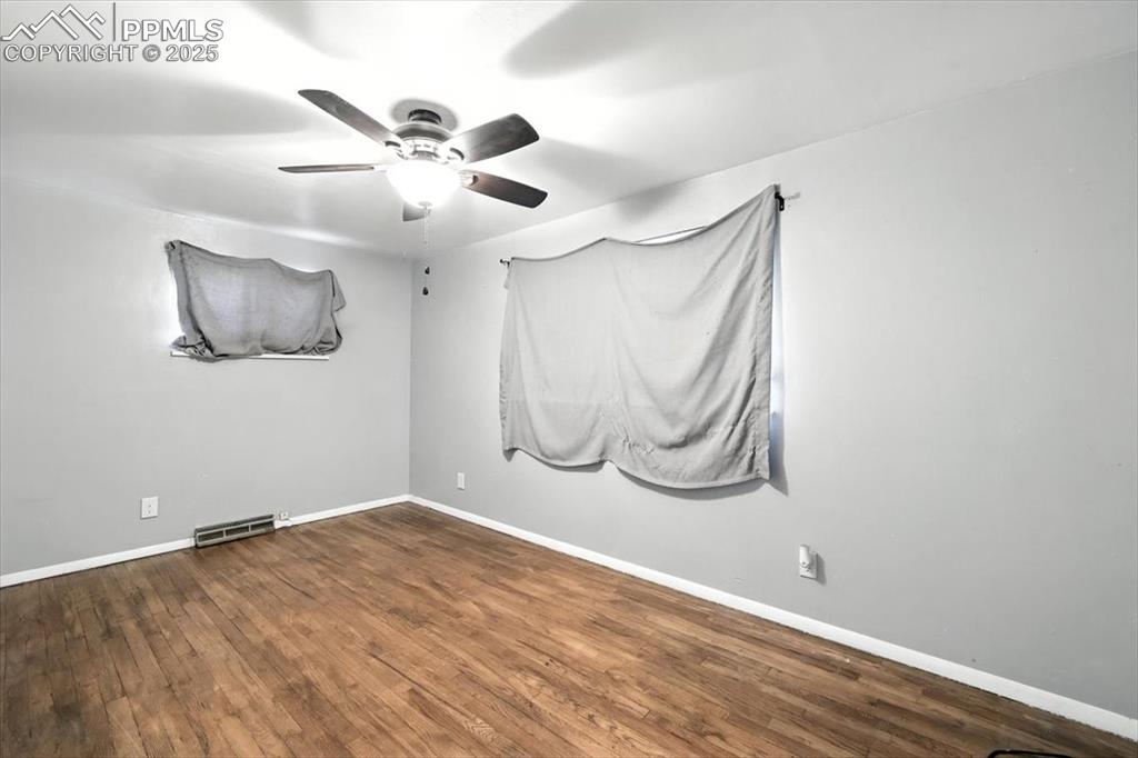 Unfurnished room featuring ceiling fan and wood finished floors