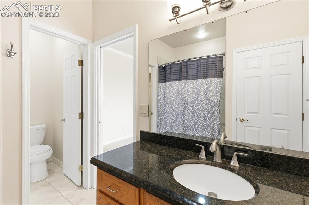 Full bath featuring vanity and a shower with curtain