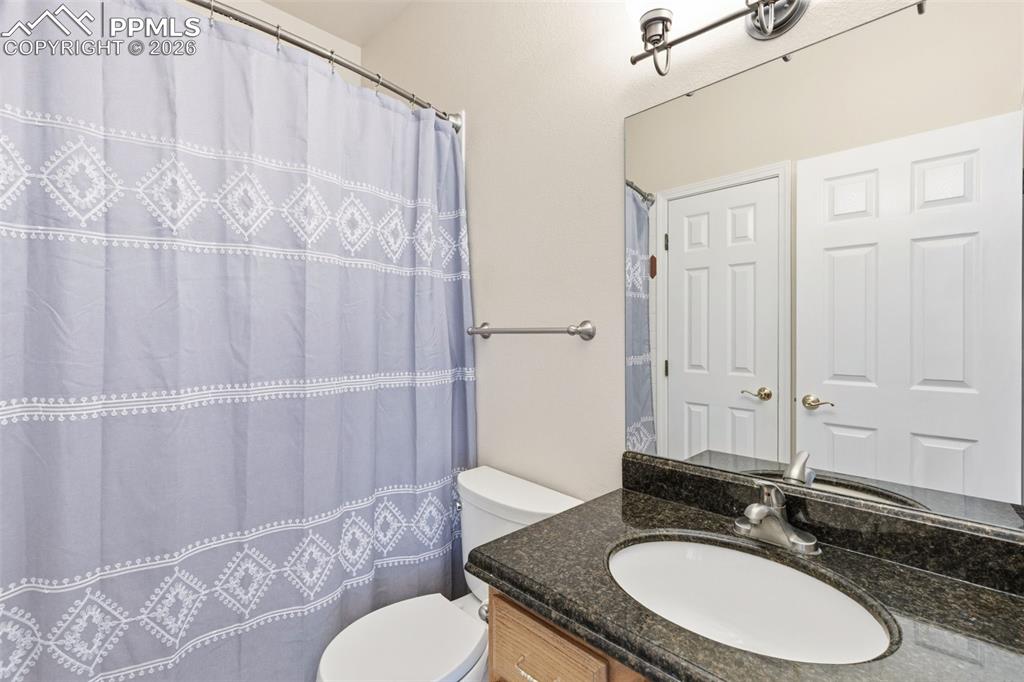 Bathroom with vanity and a shower with shower curtain