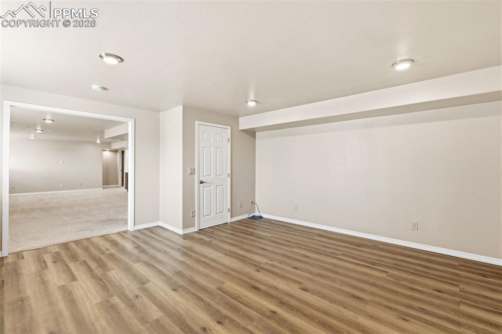Spare room featuring baseboards and light wood-style floors