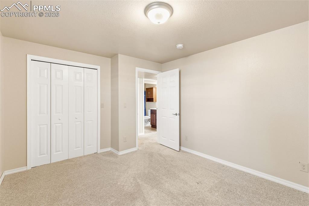 Unfurnished bedroom with carpet flooring and a closet