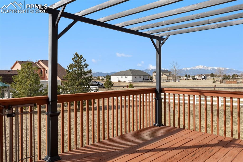 Deck with a residential view and a mountain view