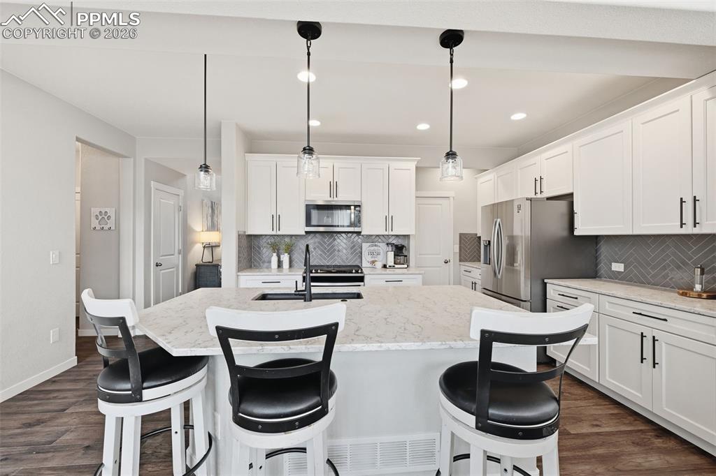 Extra cabinets leading back to the walk-in pantry
