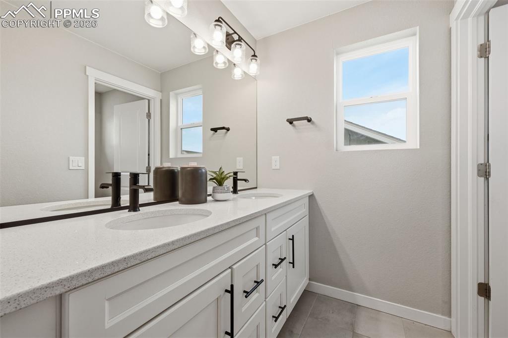 Secondary full bathroom upstairs with double vanity and separate wet area