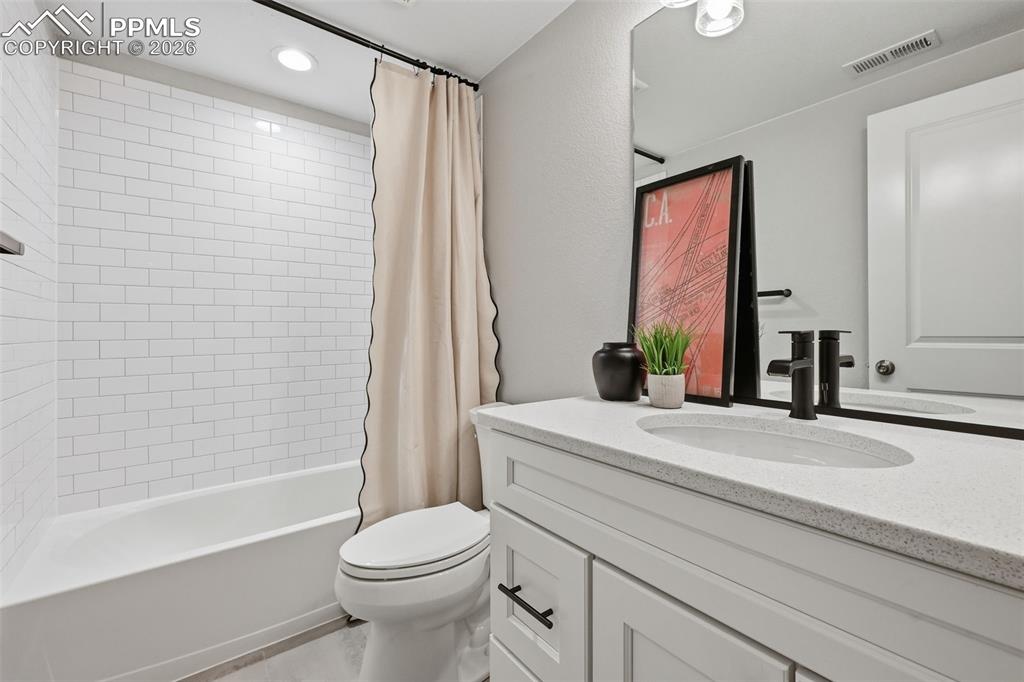 Basement full bathroom with upgraded quartz countertops