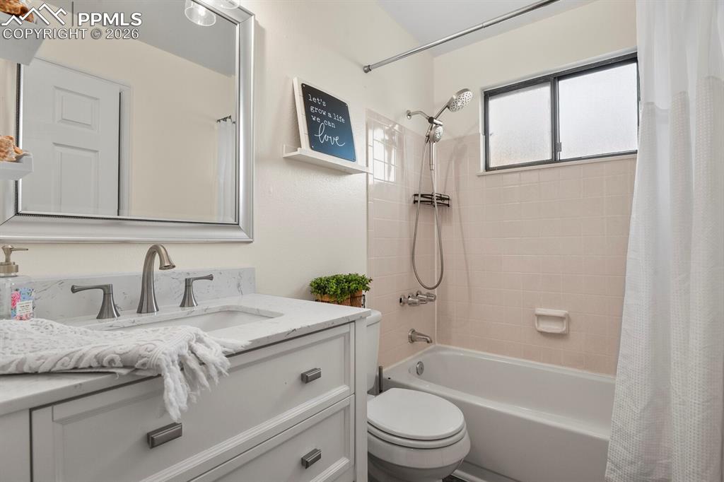 Full bath featuring vanity and shower / bath combo