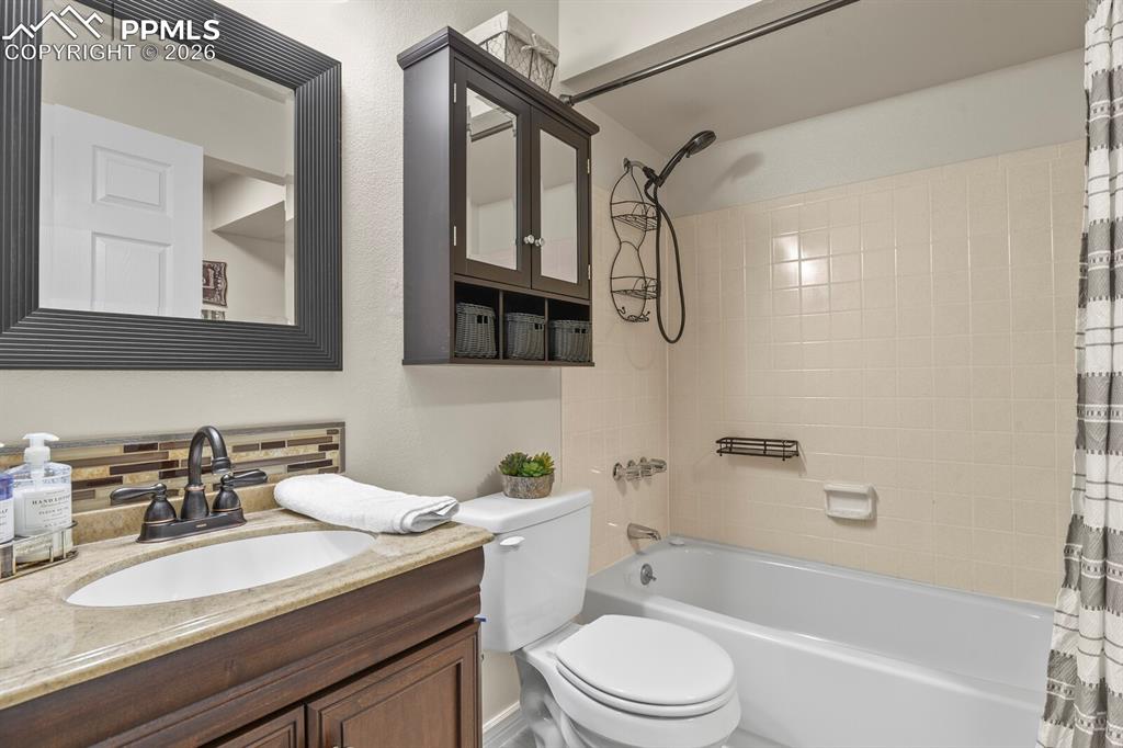 Bathroom with vanity and shower / bath combination with curtain