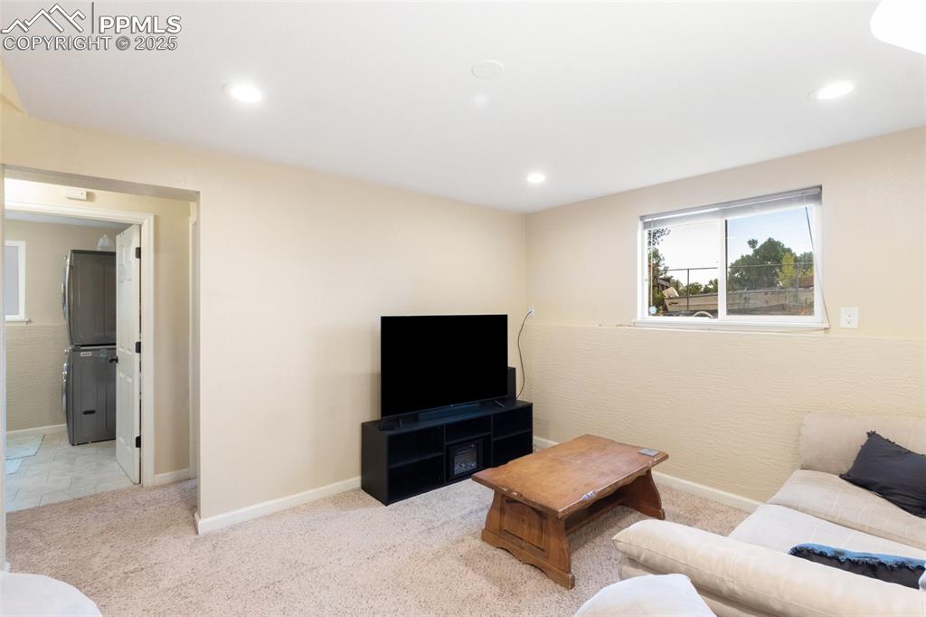 Carpeted living room with recessed lighting