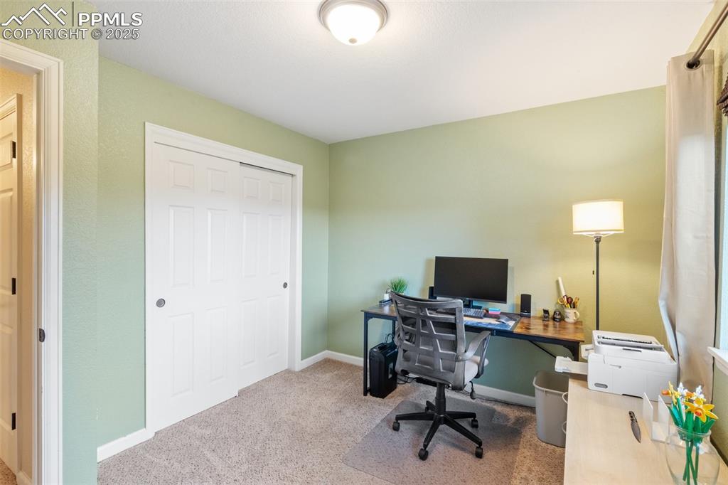 Office area featuring carpet flooring and baseboards