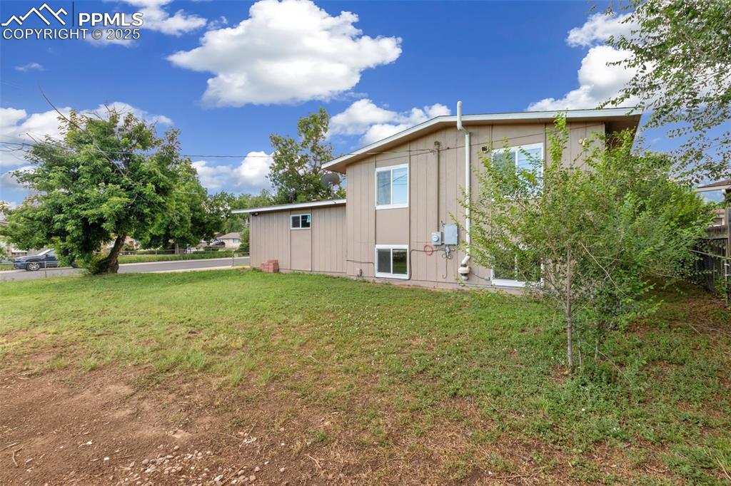 View of side of home with a central air condition unit