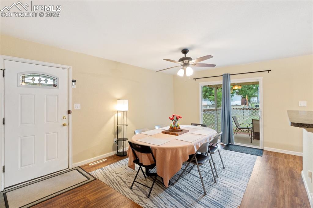 Dining area with wood finished floors and a ceiling fan