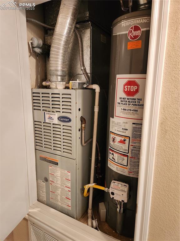 Utility room with gas water heater and heating unit