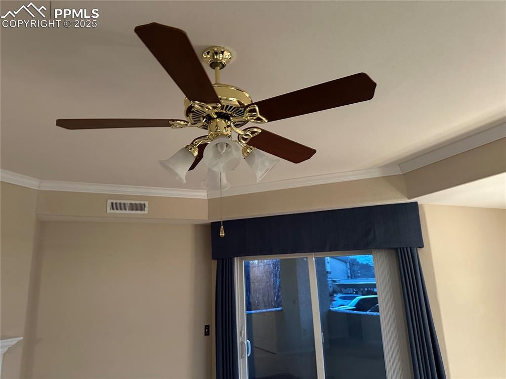Detailed view of ceiling fan and ornamental molding