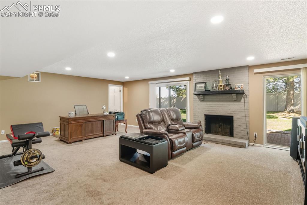 Family room with fireplace and walkout to lower level patio