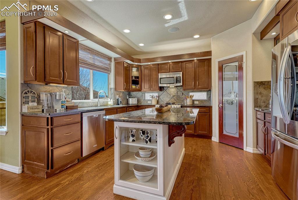 Kitchen with natural granite countertops and a large island