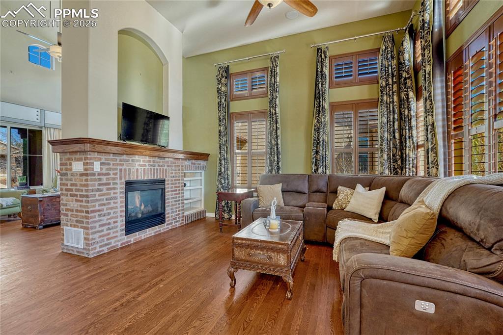Large family room with built-in shelves and plantation shutters