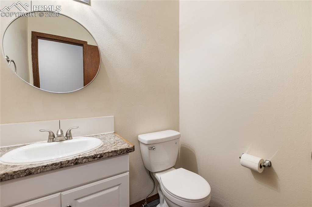 The bathroom with a vanity and a toilet!