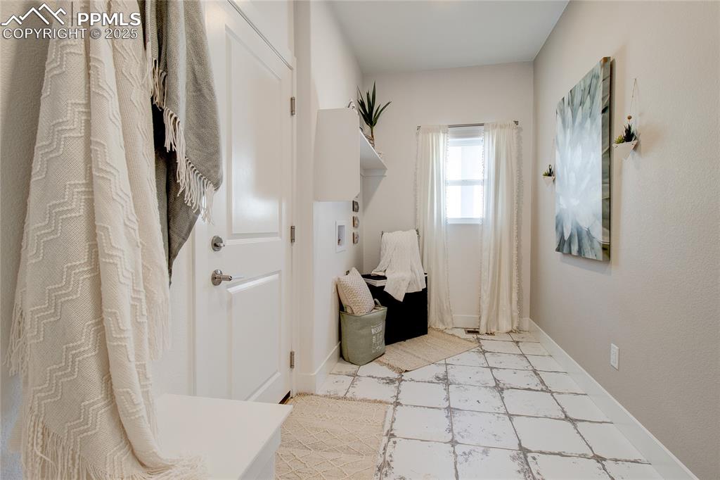 Laundry room featuring washer hookup and light flooring