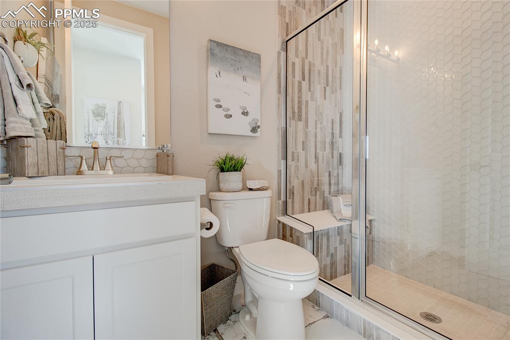Full bath featuring vanity and a stall shower