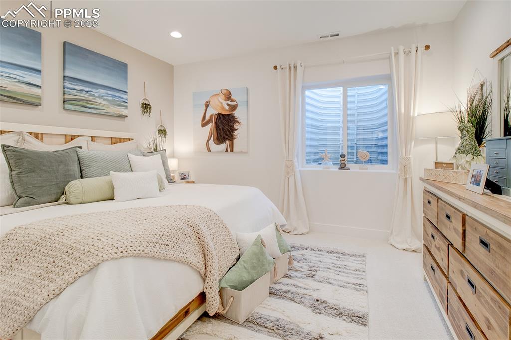 Bedroom featuring light colored carpet and recessed lighting