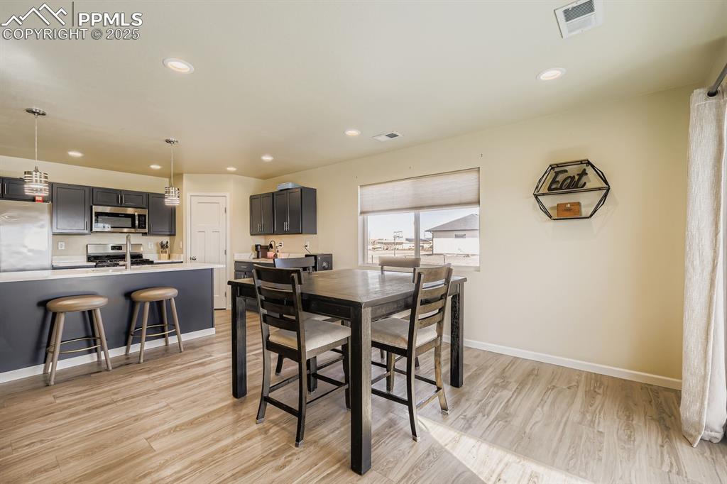 Dining area featuring light wood-style flooring and recessed lighting