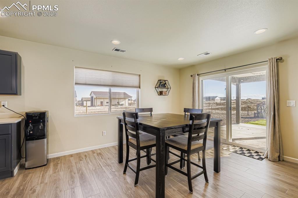 Dining space featuring recessed lighting, light wood-style floors, and plenty of natural light