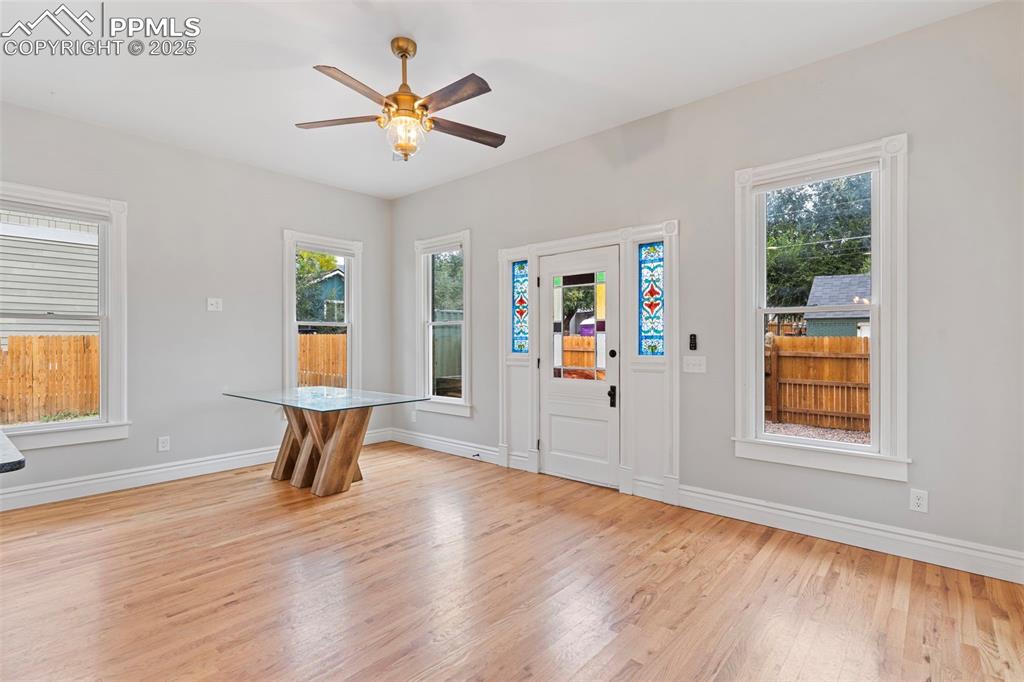 Foyer with light wood-style flooring, plenty of natural light, and a ceiling fan