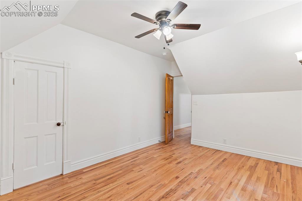 Bonus room featuring vaulted ceiling and light wood-style floors