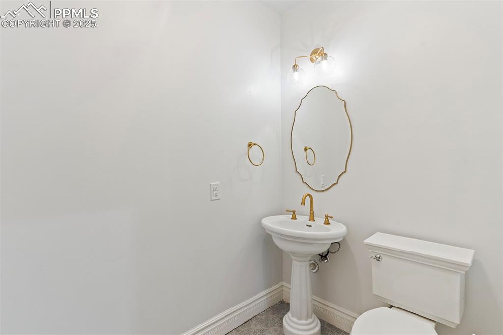 Bathroom with toilet and tile patterned flooring