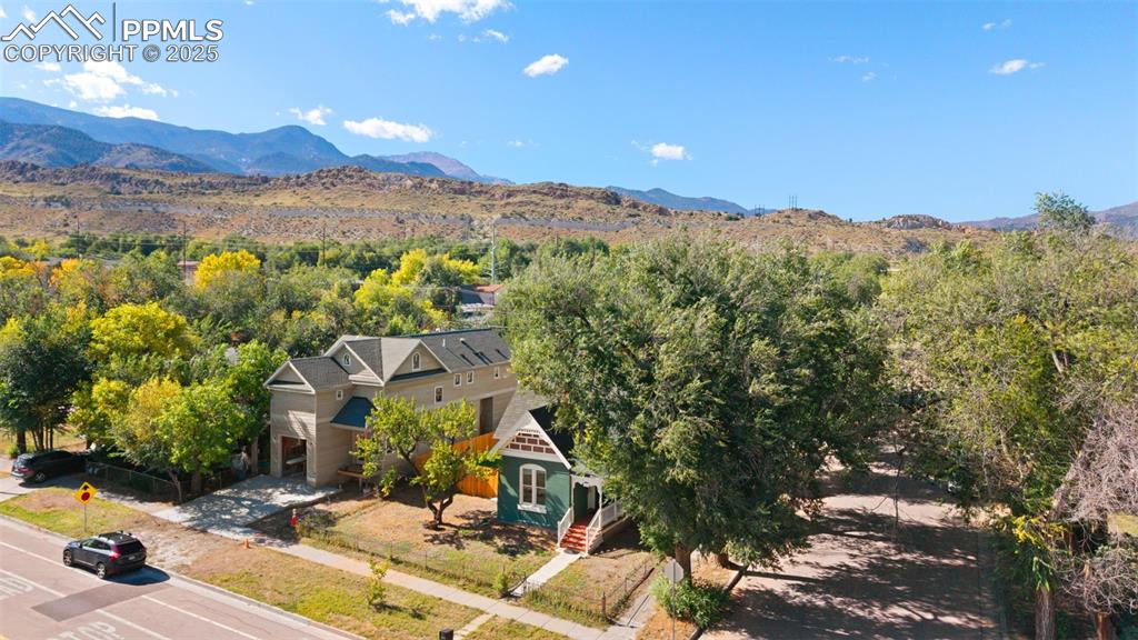 Aerial view of property and surrounding area with a mountainous background