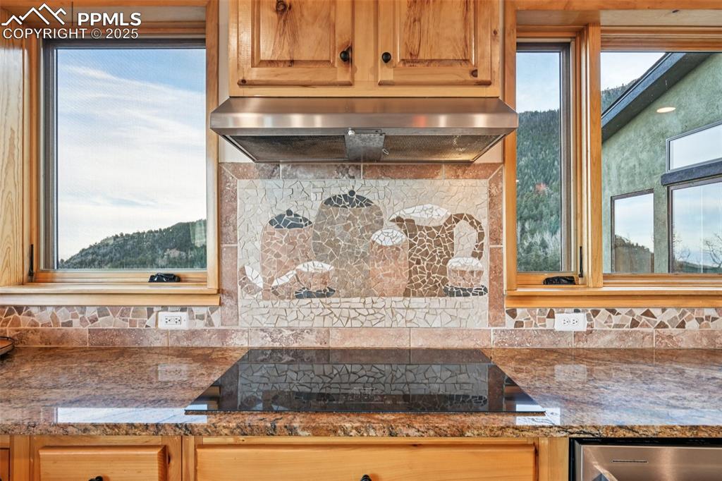 Kitchen cooktop highlighting the custom backdrop with the mountain views behind