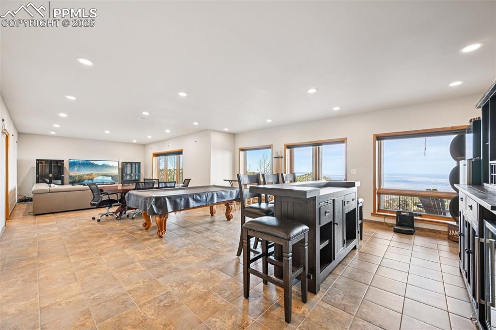 Recreation room with dry bar, pool table, sitting area and a walk out