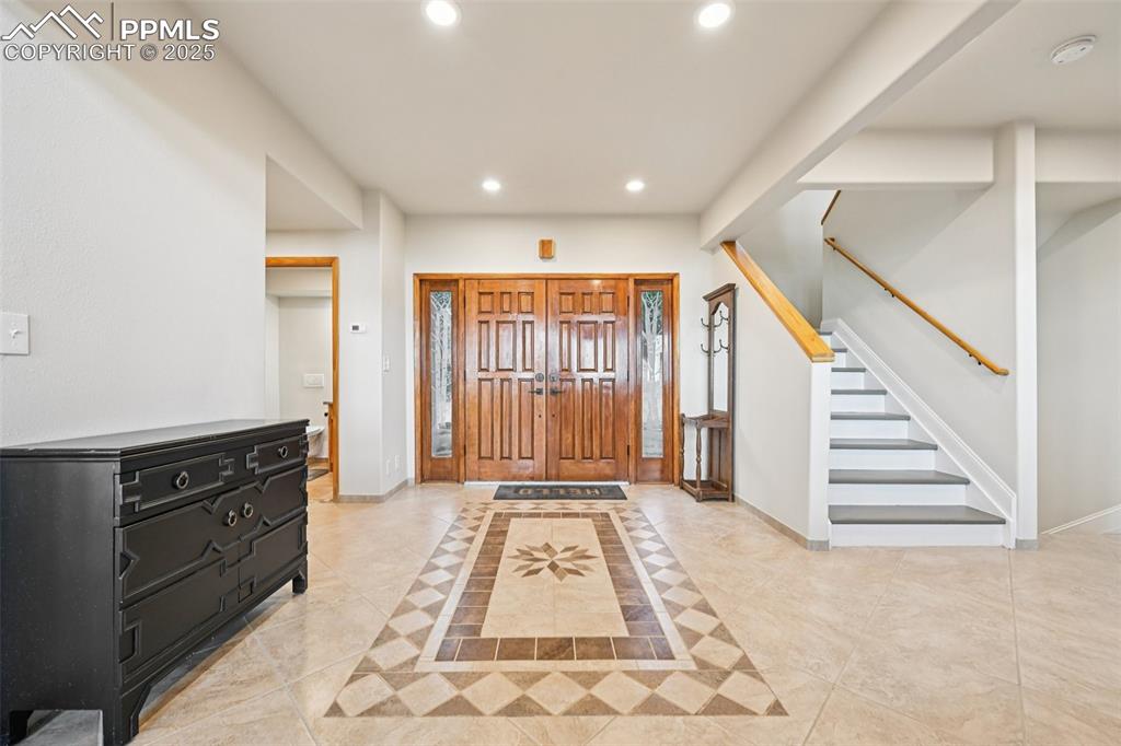 Grand foyer with tile flooring bringing you into the open concept main level