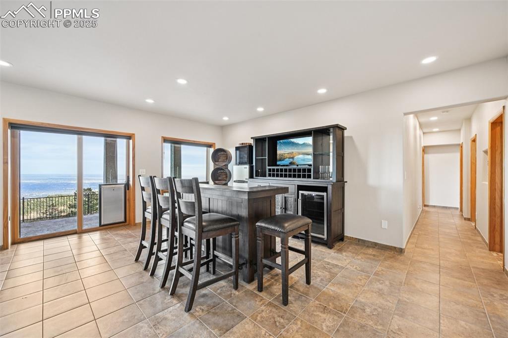 Recreation room with dry bar, pool table, sitting area and a walk out