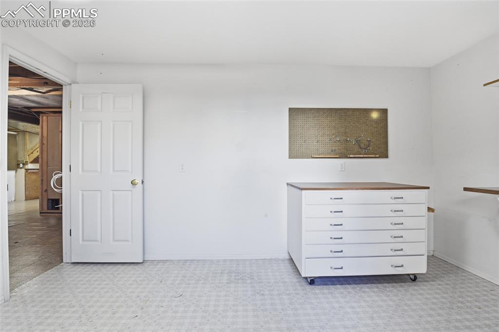 Unfurnished bedroom featuring baseboards and light floors