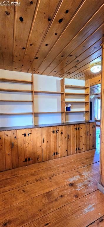 Misc room with wooden ceiling, hardwood / wood-style flooring, and wooden walls