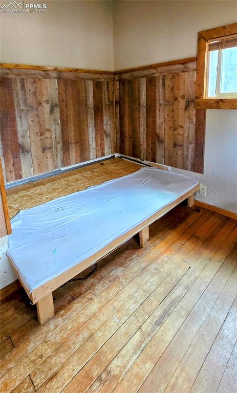 Miscellaneous room with wood-type flooring