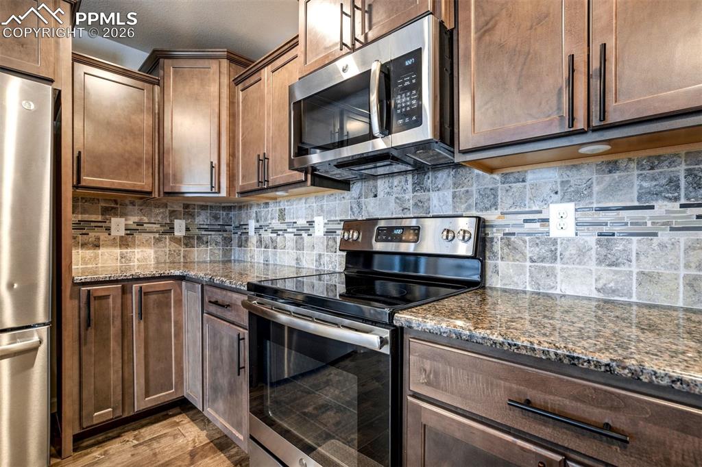 Gourmet Kitchen with Upgraded Appliances, Granite Countertops, Wood Floors, Lots of Cabinets, & Breakfast Bar!