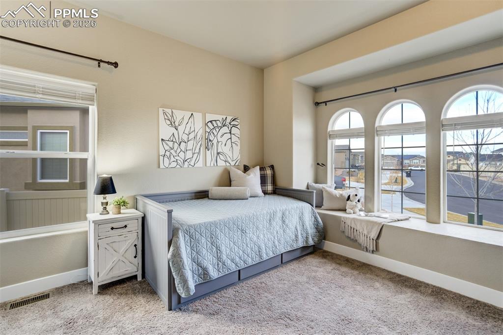 Secondary bedroom on the main level with arched windows. 