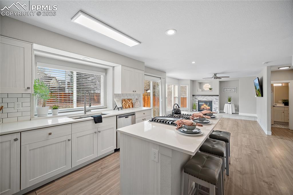 Spacious eat in kitchen with quartz counter tops, gas range. 