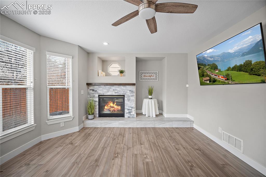 Family room with gas fireplace and bay windows. 