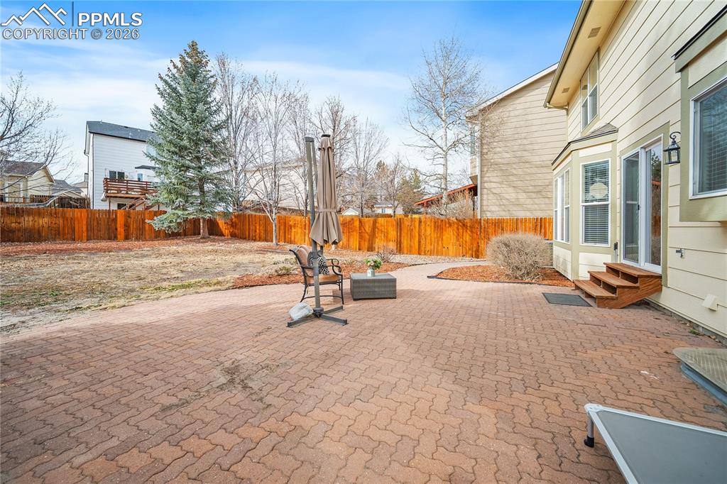 Huge paver patio and large back yard. Fully fenced with some landscaping. Lots of potential in this back yard. 