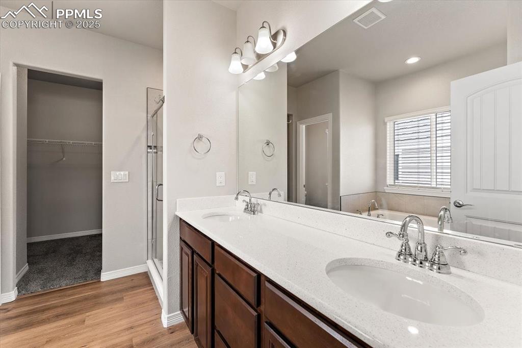 Main level Primary bedroom five-piece bathroom and large room-size closet