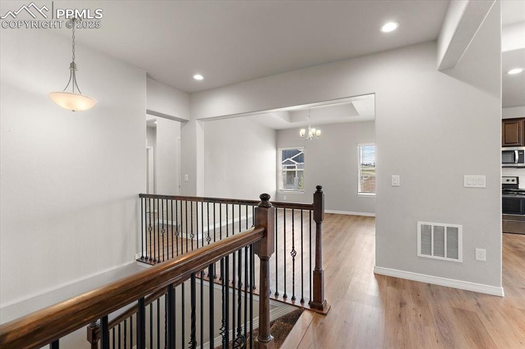 Main level staircase to the large lower level across from the formal dining room, flex room