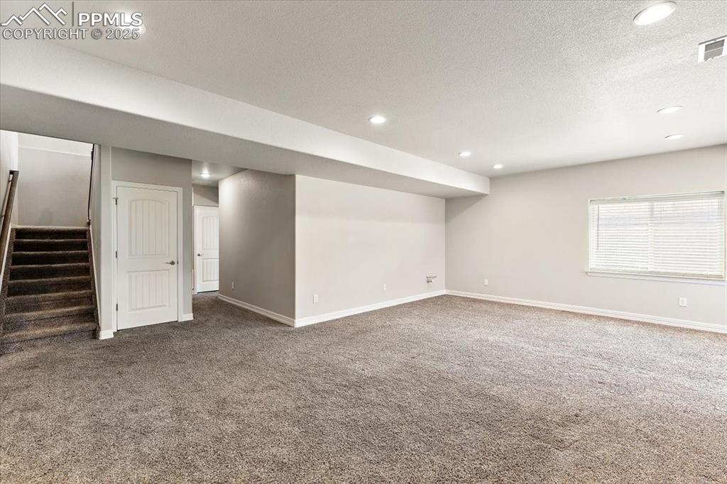Lower level family room and hallway to lower level Primary suite